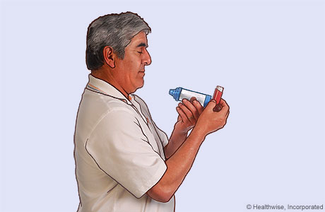 Picture of a man holding the inhaler upright