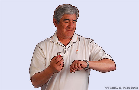 Picture of a man holding his breath and looking at his watch to count 10 seconds